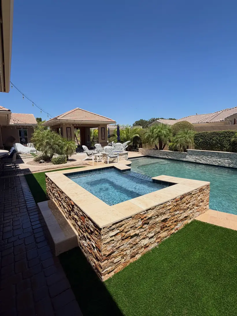 Pool and raised spa with stone facing