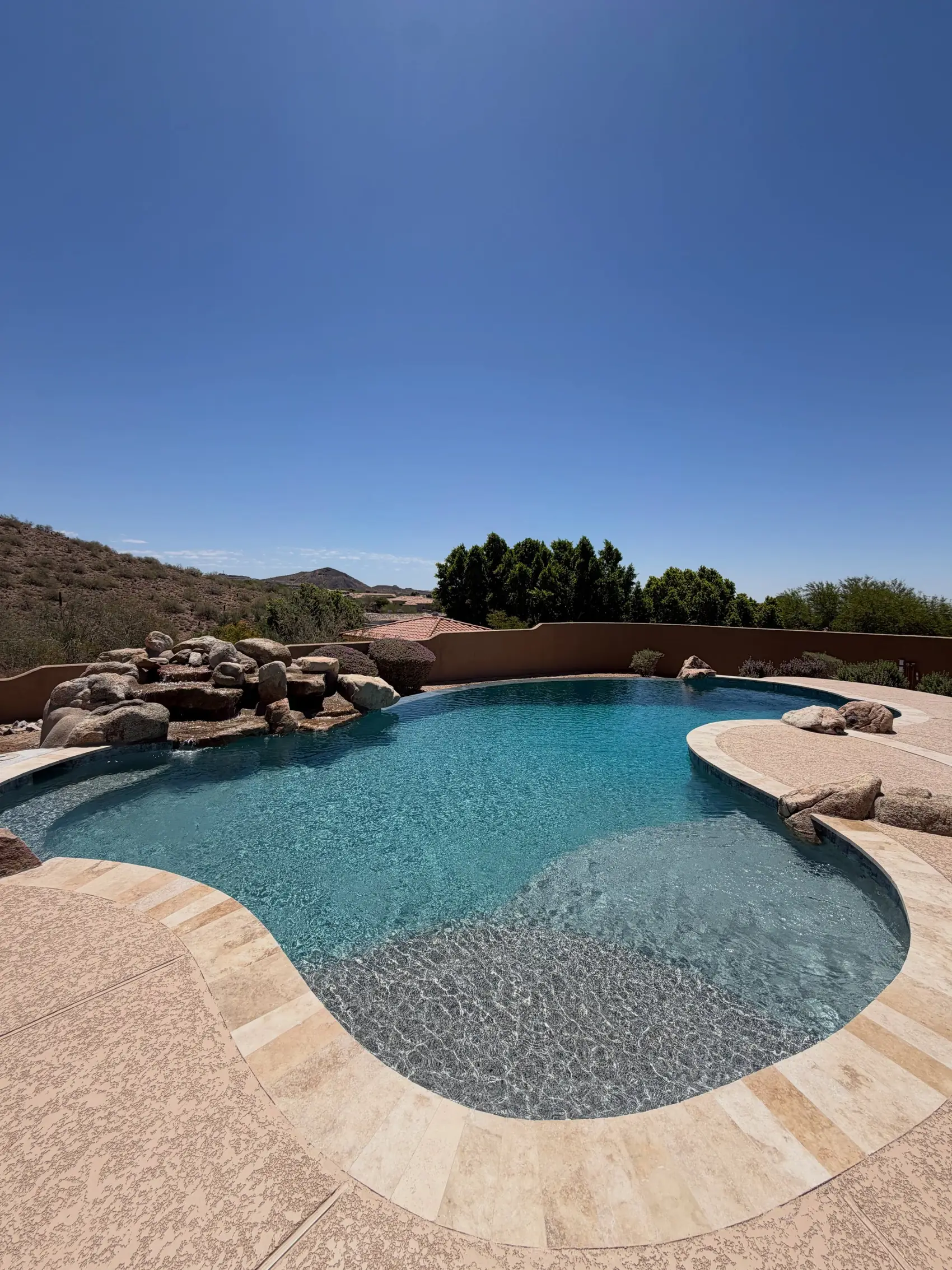A resurfaced Arizona pool with a natural rock water feature